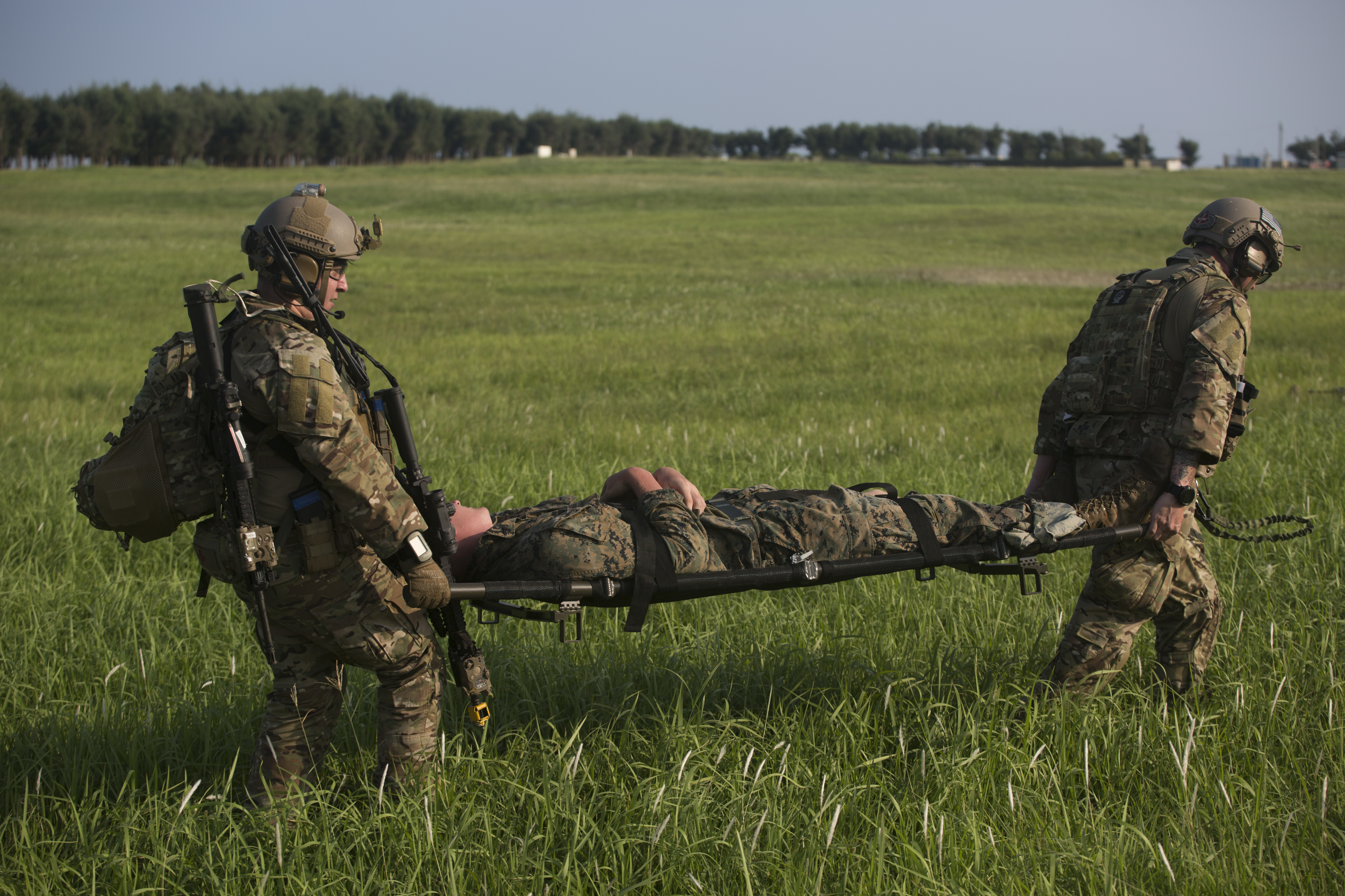 Two medics carrying an injured soldier